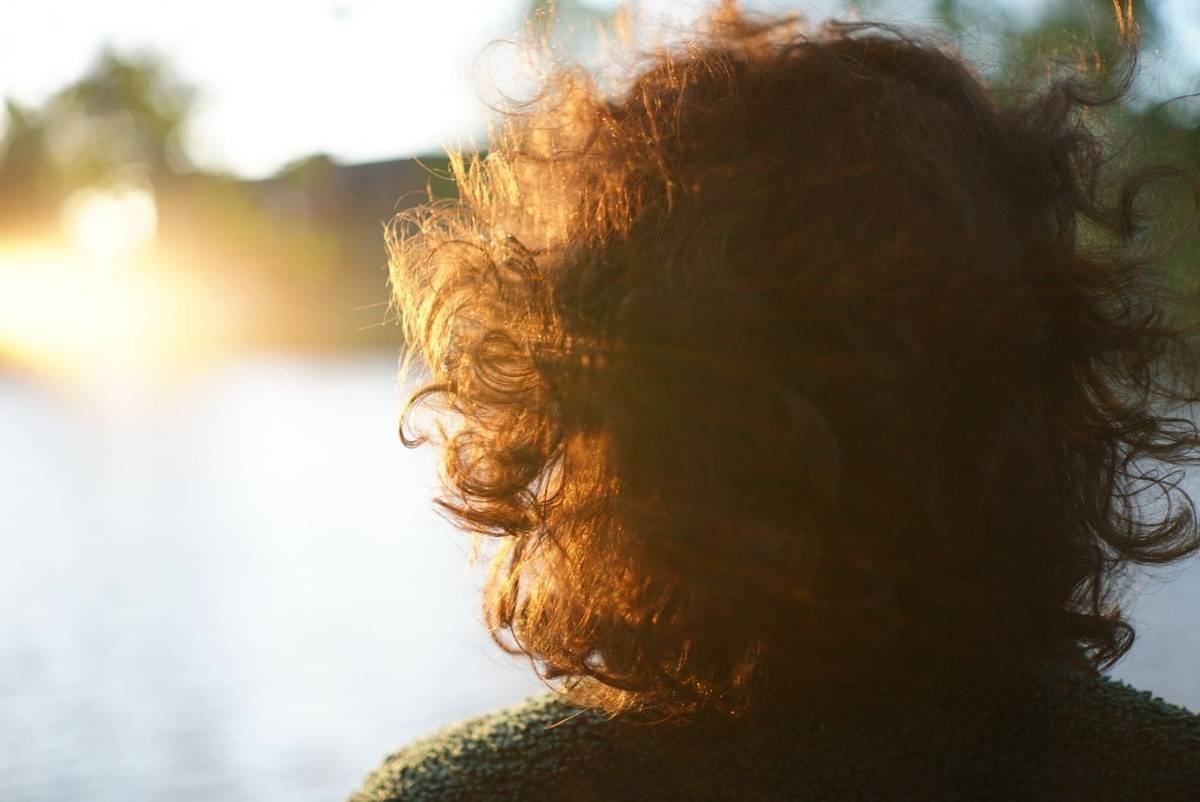 Backlit hair glowing at golden hour