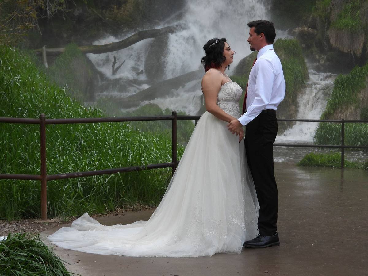 Couple in front of a waterfall