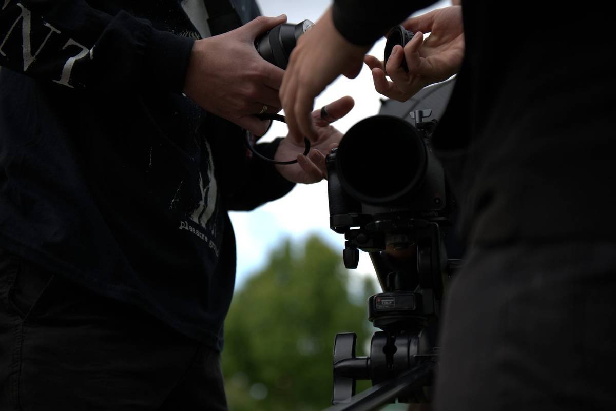 Crew adjusting a cinema camera
