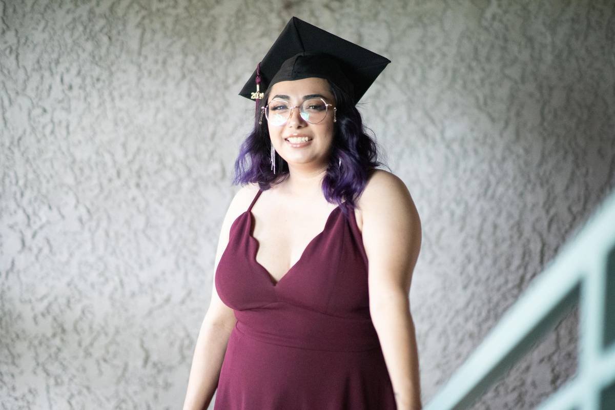 Graduate in cap and glasses smiling