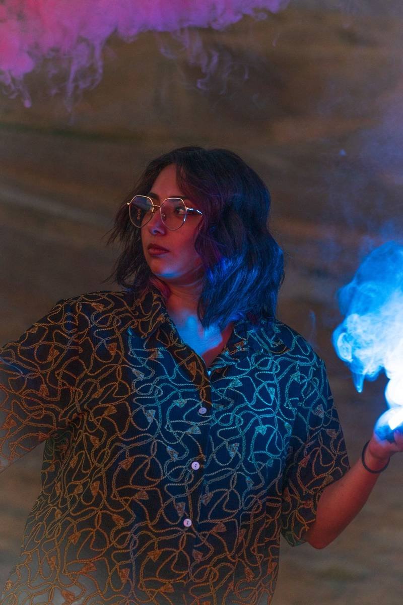 Portrait holding blue smoke