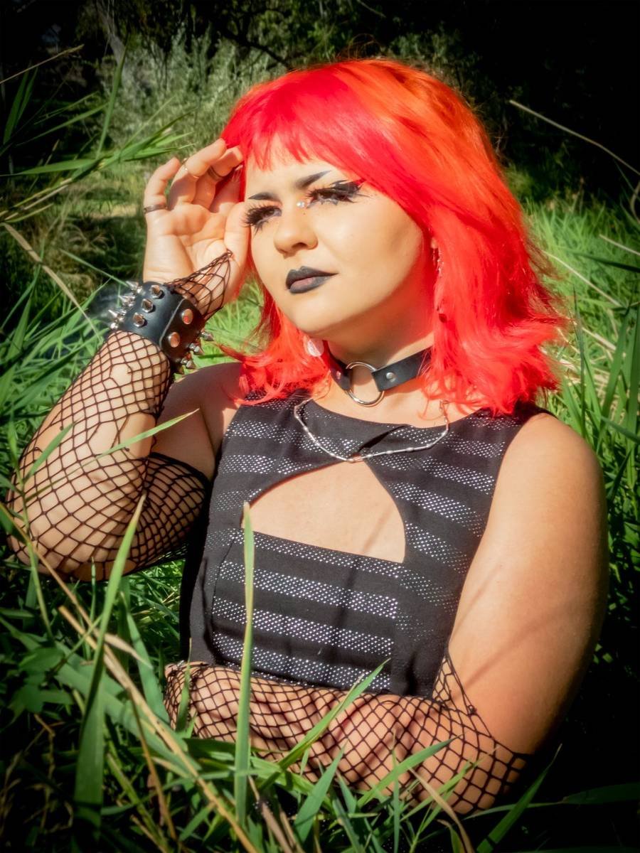 Senior shading her eyes in tall grass