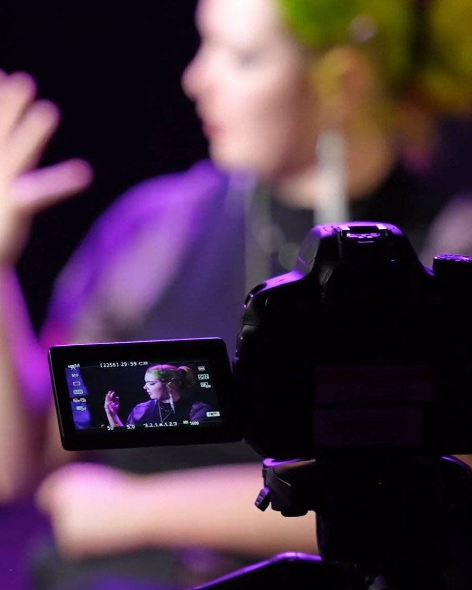 Trinidy Jordan on camera, seen on the flip screen of a DSLR during an interview shoot
